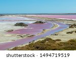 The Salin-de-Giraud salt farm with pink purple salty sea water in man-made salin evaporation pans, salt mining in Camargue, Southern France, Europe