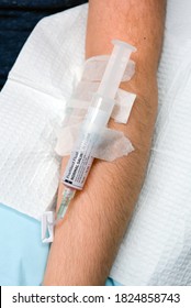 Saline Flush Connected To IV In Patient's Arm