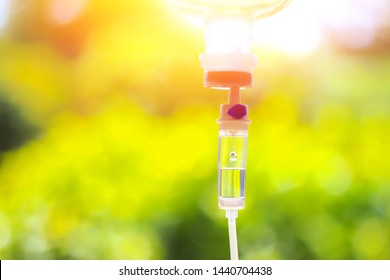 Saline iv bag intravenous drip hospital room,Medical Concept,treatment and injection vitamin natural drug infusion care chemotherapy concept.green light background hospital,Selective focus