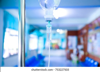 Saline iv bag intravenous drip hospital room,Medical Concept,treatment patient emergency and injection drug infusion care chemotherapy concept.blue light background hospital,Selective focus 