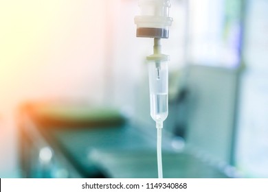 Saline iv drip fluid intravenous drop  hospital room,medical concept,treatment emergency and injection drug infusion care therapy chemotherapy, flare light background 
