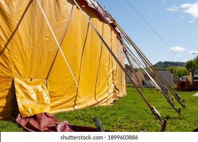 Salins-les-Bains, France - April 30 2008 - A Side Of The Bright Yellow Big Top Tent Of Cirque Plume, An Internationally Renowned Contemporary Circus Company.  Image Has Copy Space.