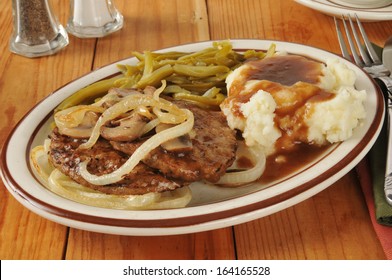 Salisbury Steak Smothered In Gravy With Sauteed Onions And Mushrooms