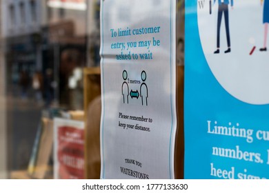 Salisbury, Wiltshire, England - July 6, 2020, Waterstones Book Store With COVID 19 Health And Safety Social Distancing Information Sign For Shoppers In Retail Store Window