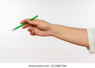 Saliva Suction Tube In Hand On White Background, Close-up