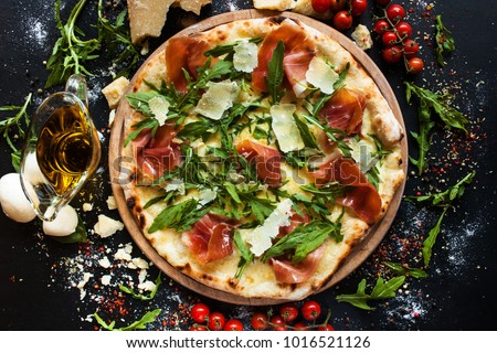Salmon and arugula pizza. Light and tasty restaurant meal for a foodie
