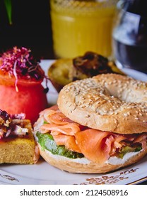 salmon avocado cream bagel for brunch at the restaurant with potato and tomato
