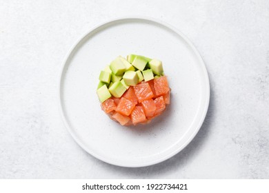 Salmon Avocado Tartare On White Stone Table Background