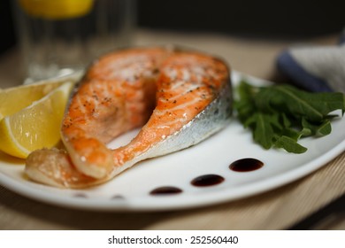 Salmon With A Balsamic Vinegar Sauce , Fresh Salad And Lemon 