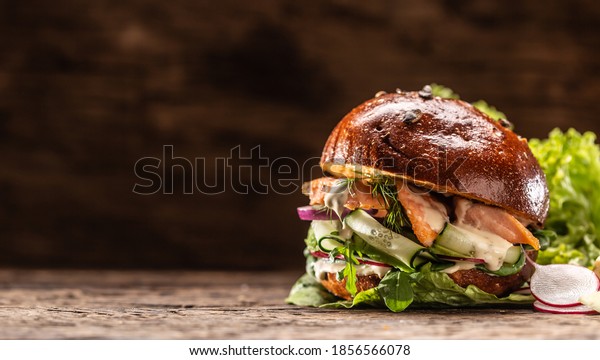 Salmon burger stuffed with vegetable salad avocado\
and dill.