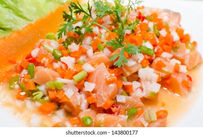 Salmon carpaccio - fresh salmon slices in marinade on burlapsack background