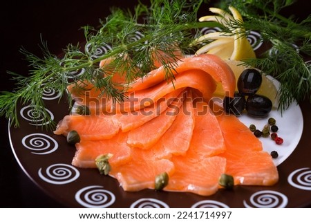 Salmon carpaccio with lemon, olives and dill