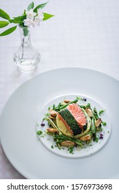 Salmon With Dill  And Sauteed Vegetables Served On White Plate Over White Texture Background. Top View, Copy Space. Plating, Fine Dining