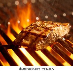 Salmon Fillet On The Grill With Flames Closeup