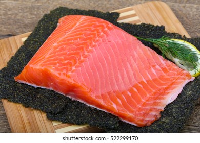 Salmon Fillet On Nori Background With Dill And Lemon