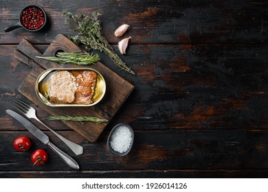 Salmon, Fish Preserves Canned Smoked Fish Set, On Wooden Cutting Board, On Old Dark Wooden Table Background With Herbs And Ingredients, Top View Flat Lay, With Copyspace And Space For Text