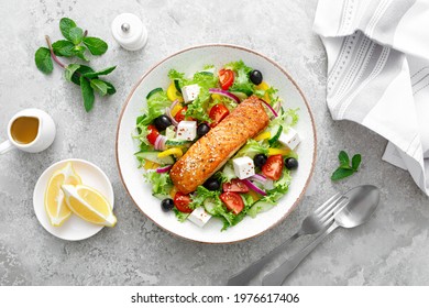 Salmon Fish Salad. Fresh Vegetable Greek Salad With Tomato, Pepper, Lettuce, Olives, Cucumbers, Feta Cheese And Grilled Salmon Fish Fillet, Healthy Food, Omega 3, Keto Diet, Mediterranean Cusine, Top