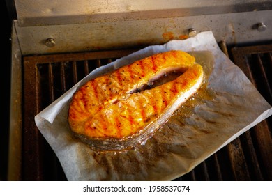 Salmon Fish Steak Cooking.Piece Of Red Fish Fillet Being Cooked On Grill Pan In Seafood Restaurant Kitchen.Gourmet Seafood Dish Grilling For Dinner.Download Royalty Free Curated Food Images Collection