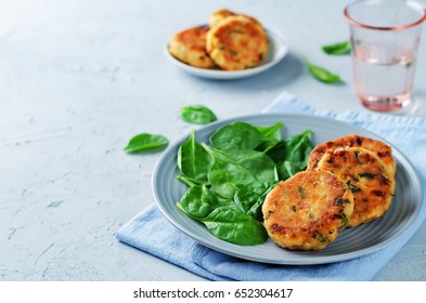 Salmon fritters with spinach on a stone background. toning. selective focus