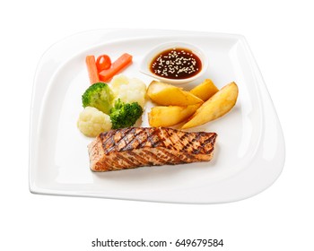 Salmon Grilled Steak Served With Fried Potato Carrot, Broccoli, Cauliflower, Sweet Sauce And Sesame In Ceramic Dish Isolated On White, Include Pen Tool Path