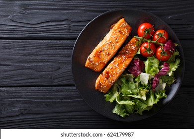 Salmon In Honey-soy Glaze And Fresh Vegetable Close-up On A Plate. Horizontal View From Above
