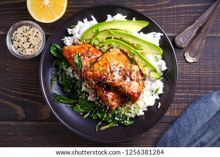 Salmon in honey-soy glaze with rice, spinach and avocado. overhead, horizontal