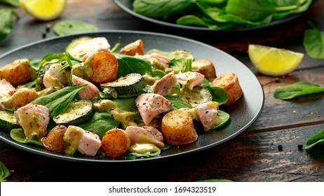 Salmon, New Potato, Courgette And Spinach Salad On Wooden Table