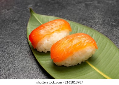 Salmon Nigiri On Green Leaf.  Close Up. Black Background