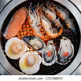 Salmon, Oyster, River Prawn, Scallop On A Grill Stove.