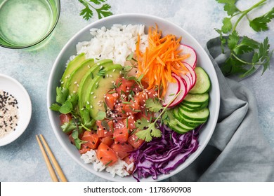 salmon poke bowl (avocado, salmon, carrot, cucumber, red cabbage, radish and rice), top view - Shutterstock ID 1178690908