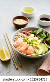 Salmon Poke Bowl With Salad, Avocado, Edamame Beans, Pineapple And Sesame Brown Rice Poke Bowl Top View, Clean Eating Concept Traditional Hawaiian Dish