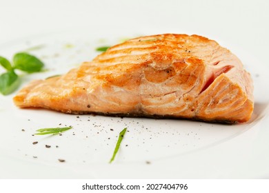 Salmon Red Fish Steak On A Plate. Delicious Mediterranean Food. Side View. Close-up. White Background.