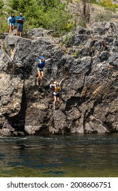 Salmon River - 7-2-2021:  Two River Rafters Jumping From A Cliff Into The Salmon Rivr In The Frank Church River Of No Return Wilderness Area In Northern Idaho USA.  People Blurred To Show Motion.