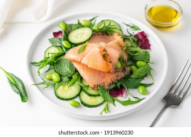 Salmon salad with cucumber, spinach, mizuna salad, radicchio. Healthy food, diet. Salted salmon in modern plate on white background  - Shutterstock ID 1913960230