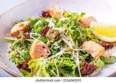 Salmon Salad With Dried Tomatoes, Cheese And Fresh Greens. Closeup