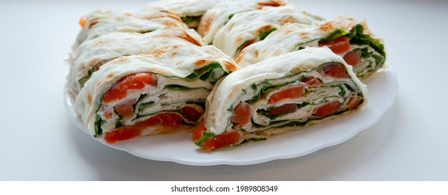 Salmon Salad Sandwich On A White Plate. Roll Lavash Sandwich With Red Fish And Lettuce. Thin Armenian Lavash Or Lavash. Snack.