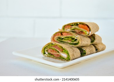 Salmon Salad Sandwich On A White Plate. Roll Lavash Sandwich With Red Fish And Lettuce. Thin Mexican Tortilla. Selective Focus