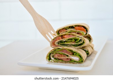 Salmon Salad Sandwich On A White Plate. Roll Lavash Sandwich With Red Fish And Lettuce. Thin Mexican Tortilla. Selective Focus