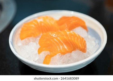 Salmon Sashimi, 

Fresh salmon sashimi slices served on ice in a white bowl, showcasing vibrant orange color and rich texture, perfect for Japanese cuisine lovers