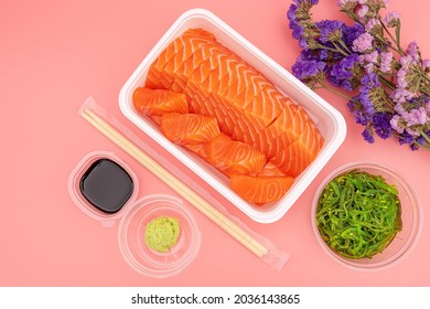 Salmon sashimi in a white box, ready-to-eat delivery style
