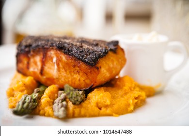 Salmon Steak With Asparagus And Sweet Potato Mash Served On White Plate