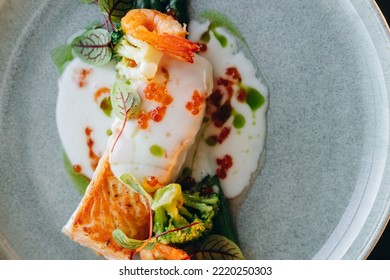 Salmon Steak Covered In Cream Sauce, Garnished With Shrimp And Red Caviar. Restaurant Service.