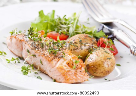 salmon steak with potato and salad
