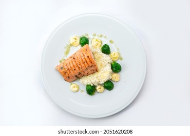 Salmon Steak With Rice And Cauliflower In A Plate. Isolated On White Background.