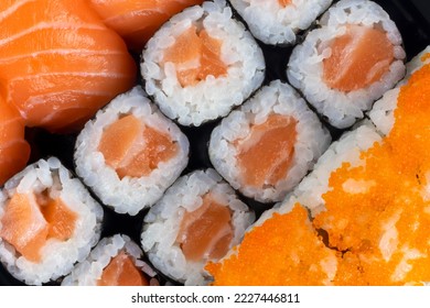 Salmon Sushi And Sashimi Nigiri And Maki Roll Closeup. Delicious Japanese Food With Fresh Fish, Restaurant Delivery Set