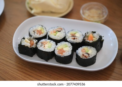 salmon sushi in the white dish