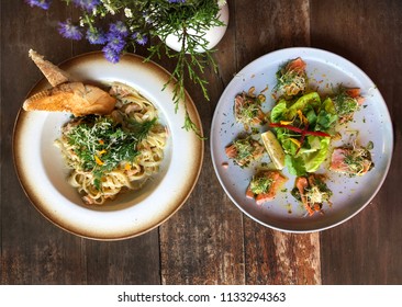 Salmon Tataki And  Salmon Pasta. Fancy Dinner Close-up. Slices Of Sashimi Grade Red Fish Seared Lightly To Keep The Fish Raw Inside. Japanese And Italian Cuisine. Gourmet Fine Dining Restaurants.