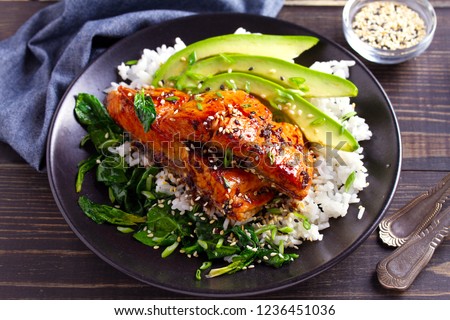 Salmon teriyaki rice bowl with spinach and avocado. 