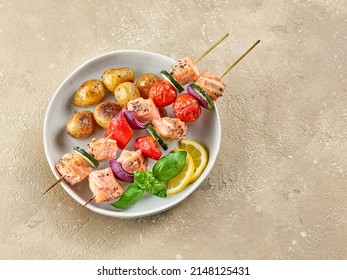 Salmon And Vegetable Skewers With Roasted Potatoes On Restaurant Table, Top View