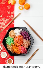 Salmon Yee Sang or Yusheng, a Chinese New Year Celebration Dish, Top View Red Imlek Concept 